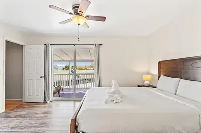 a bedroom with a bed and a ceiling fan at 5218 Beach Dr C in Panama City Beach