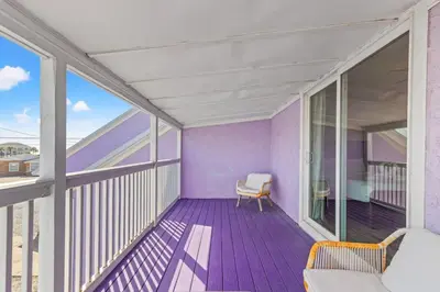a balcony with purple flooring and a chair on it at 5218 Beach Dr C in Panama City Beach