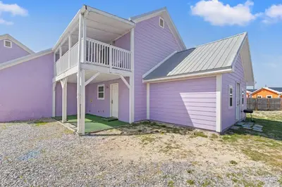 a purple house with a balcony on top of it at 5218 Beach Dr C in Panama City Beach