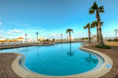 a large swimming pool with palm trees in a resort at Laketown Wharf 335! 1 BD, 2 Bathroom with Amazing Amenities in Panama City Beach