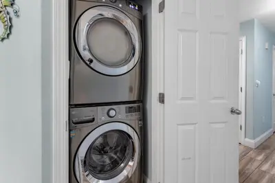 a washer and dryer in a room next to a door at Laketown Wharf 335! 1 BD, 2 Bathroom with Amazing Amenities in Panama City Beach