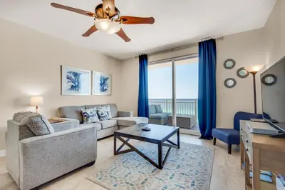 a living room with a couch and a ceiling fan at Sterling Reef 802 in Panama City Beach
