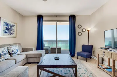 a living room with a couch and a table at Sterling Reef 802 in Panama City Beach