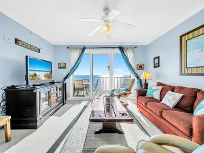 a living room with a couch and a tv at Grandview East 1004 in Panama City Beach