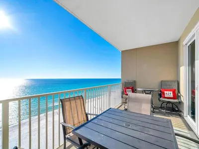 a balcony with a table and chairs and the ocean at Grandview East 1004 in Panama City Beach