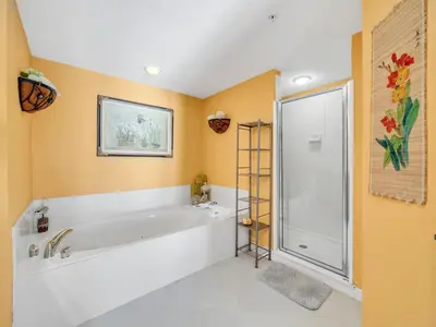 a bathroom with a large tub and a shower at Grandview East 1004 in Panama City Beach