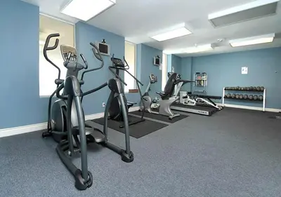 a gym with three tread machines in a room at Grandview East 1004 in Panama City Beach
