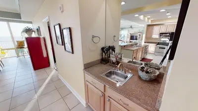 a kitchen with a sink and a red refrigerator at Marisol 1001 in Panama City Beach