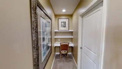 a hallway with a table and a chair next to a door at Marisol 1001 in Panama City Beach