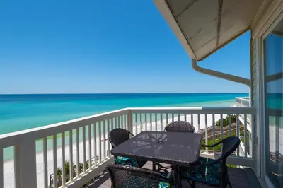 a table and chairs on a balcony overlooking the beach at Mistral Unit 18 in Santa Rosa Beach
