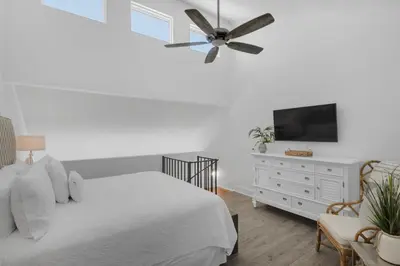 a white bedroom with a bed and a ceiling fan at Mistral Unit 18 in Santa Rosa Beach