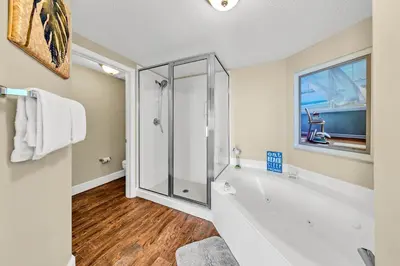 a bathroom with a tub and a glass shower at Majestic Beach Towers 1-1803 in Panama City Beach