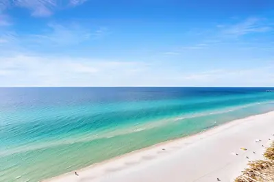 a view of a beach with chairs and the ocean at Majestic Beach Towers 1-1803 in Panama City Beach