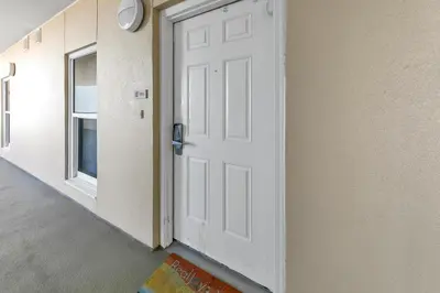 a white door in a room with a window at Majestic Beach Towers 1-1803 in Panama City Beach