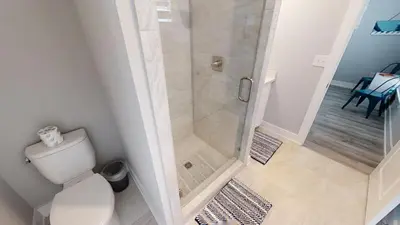 a bathroom with a shower with a toilet at Seabreeze 114 in Panama City Beach