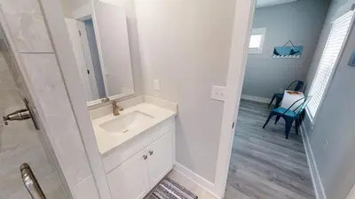 a bathroom with a sink and a mirror at Seabreeze 114 in Panama City Beach