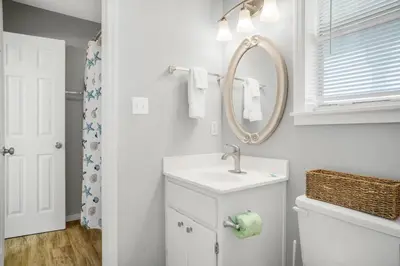 a white bathroom with a sink and a mirror at Beachside Villas 732- Southbound Serenity in Santa Rosa Beach