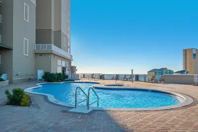 a swimming pool on the side of a building at Grand Panama 1-305 in Panama City Beach