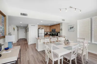 a kitchen and dining room with a table and chairs at Marisol 501 in Panama City Beach