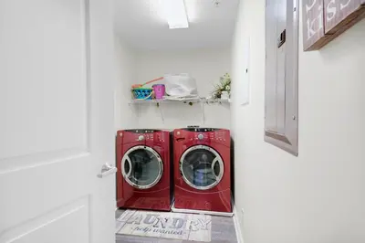 a laundry room with a red washer and dryer at Marisol 501 in Panama City Beach