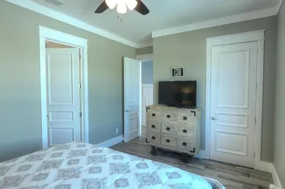 a bedroom with a bed and a tv on a dresser at Making Waves - Huge Heated Beachfront Pool & Hot Tub! Best In Pcb! in Panama City Beach