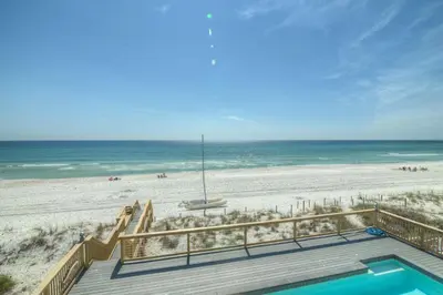 a view of the beach from the balcony of a beach house at Making Waves - Huge Heated Beachfront Pool & Hot Tub! Best In Pcb! in Panama City Beach