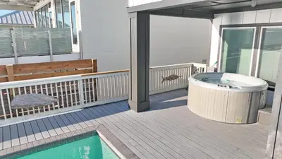 a hot tub on the balcony of a house at Making Waves - Huge Heated Beachfront Pool & Hot Tub! Best In Pcb! in Panama City Beach