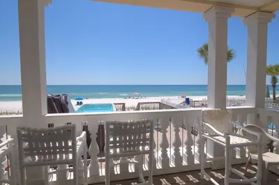 a porch with chairs and a view of the beach at Surf Song - Beachfront Home With Swimspa! in Panama City Beach