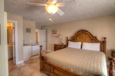 a bedroom with a bed and a ceiling fan at Surf Song - Beachfront Home With Swimspa! in Panama City Beach