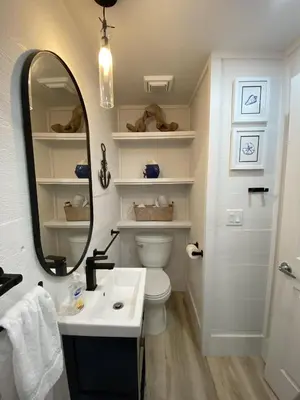 a bathroom with a sink and a mirror and a toilet at Fantasea - Wonderful Private Beachfront Home - Beautiful!!! in Panama City Beach