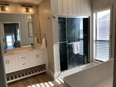 a bathroom with a shower and a large mirror at Fantasea - Wonderful Private Beachfront Home - Beautiful!!! in Panama City Beach