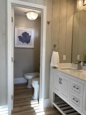 a bathroom with a toilet and a sink and a mirror at Fantasea - Wonderful Private Beachfront Home - Beautiful!!! in Panama City Beach