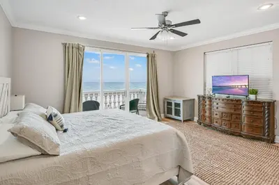 a bedroom with a bed and a view of the ocean at Cotton Sails - On The Beach - Plunge Pool! in Panama City Beach