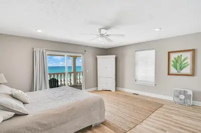 a bedroom with a bed and a view of the ocean at Cotton Sails - On The Beach - Plunge Pool! in Panama City Beach