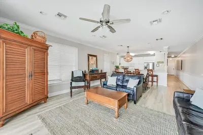 a living room with a couch and a table at Cotton Sails - On The Beach - Plunge Pool! in Panama City Beach