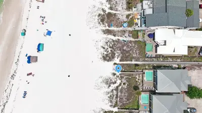 an aerial view of a beach with people on it at The Tourist Trap - Heated Private Beachfront Pool! Gorgeous!!! in Panama City Beach