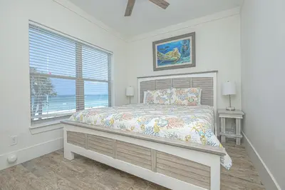 a bedroom with a bed and a window at The Tourist Trap - Heated Private Beachfront Pool! Gorgeous!!! in Panama City Beach