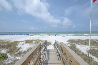a boardwalk leading to a beach with the ocean at The Tourist Trap - Heated Private Beachfront Pool! Gorgeous!!! in Panama City Beach