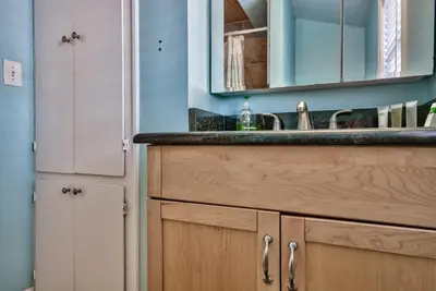 a kitchen with a sink and a mirror at Sand Blast - Lovely Beachfront Home With Tons Of Space! in Panama City Beach