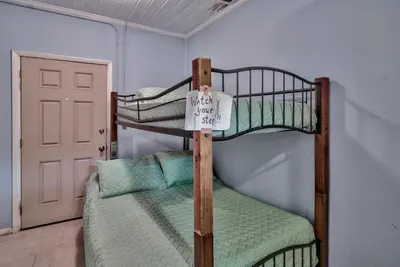 a couple of bunk beds in a room with a door at Sand Blast - Lovely Beachfront Home With Tons Of Space! in Panama City Beach