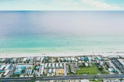 an aerial view of a parking lot next to the beach at Hook, Wine & Sinker - Private Pool! Brand New! in Panama City Beach