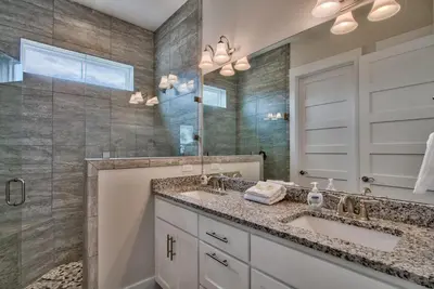 a bathroom with two sinks and a mirror at Hook, Wine & Sinker - Private Pool! Brand New! in Panama City Beach
