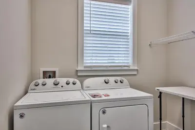 a kitchen with two white appliances and a window at Hook, Wine & Sinker - Private Pool! Brand New! in Panama City Beach