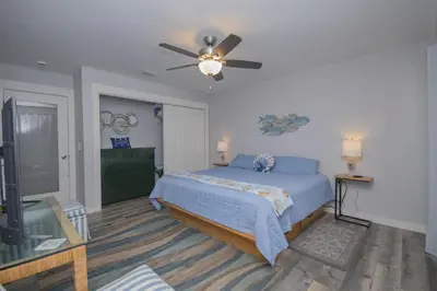 a bedroom with a bed and a ceiling fan at Island Time- Wonderful Private Beachfront Home - Beautiful!!! in Panama City Beach