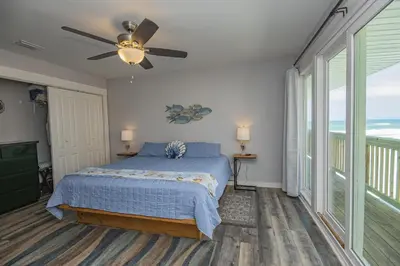 a bedroom with a bed and a ceiling fan at Island Time- Wonderful Private Beachfront Home - Beautiful!!! in Panama City Beach