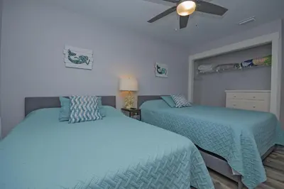 a bedroom with two beds and a ceiling fan at Island Time- Wonderful Private Beachfront Home - Beautiful!!! in Panama City Beach