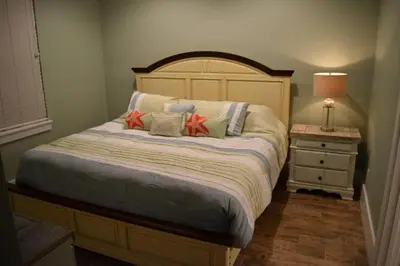 a bedroom with a large bed with pillows on it at The Lighthouse 6 Bd Home With Beachfront Pool And Hot Tub in Panama City Beach