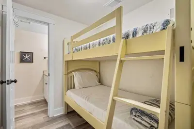 a bedroom with two bunk beds in a room at Shores Of Panama Best 3 Bedroom With Wrap-Around Balcony! in Panama City Beach