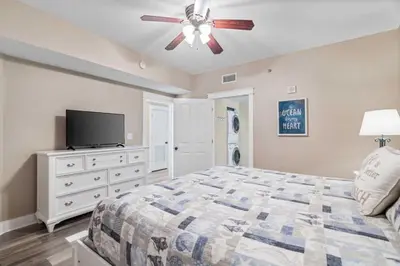a bedroom with a bed and a ceiling fan at Shores Of Panama Best 3 Bedroom With Wrap-Around Balcony! in Panama City Beach
