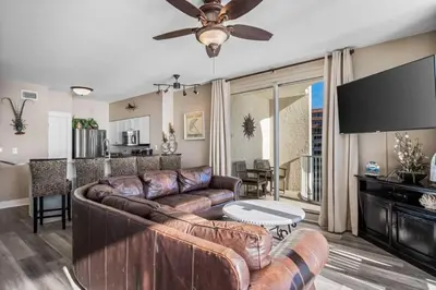 a living room with a couch and a table at Shores Of Panama Best 3 Bedroom With Wrap-Around Balcony! in Panama City Beach